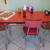 Table in red formica, 4 roc chairs, 2 extension cords, 2 drawers 60
