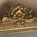 Golden mirror with a pediment from the early 20th century.