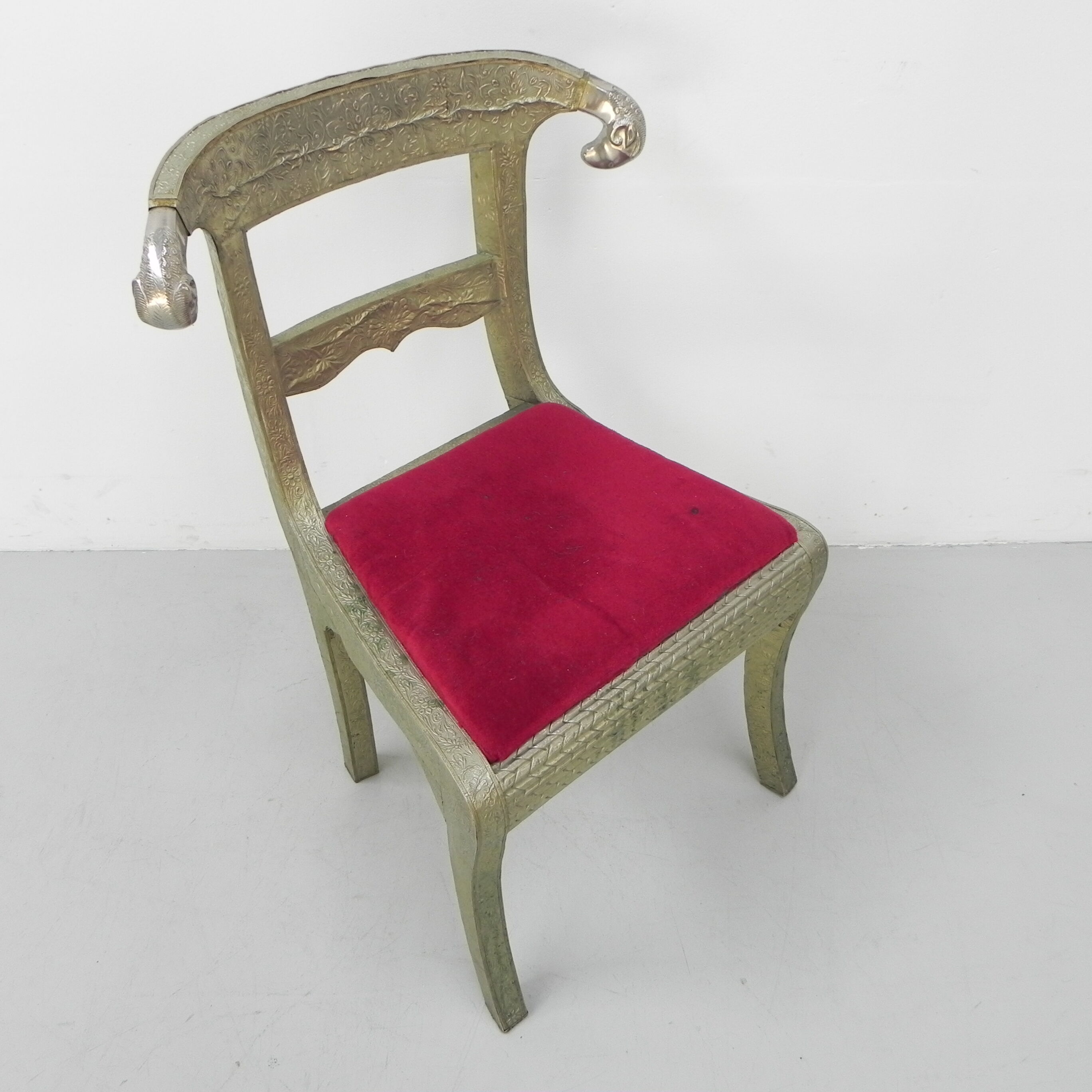 Dining chair upholstered with stamped tin