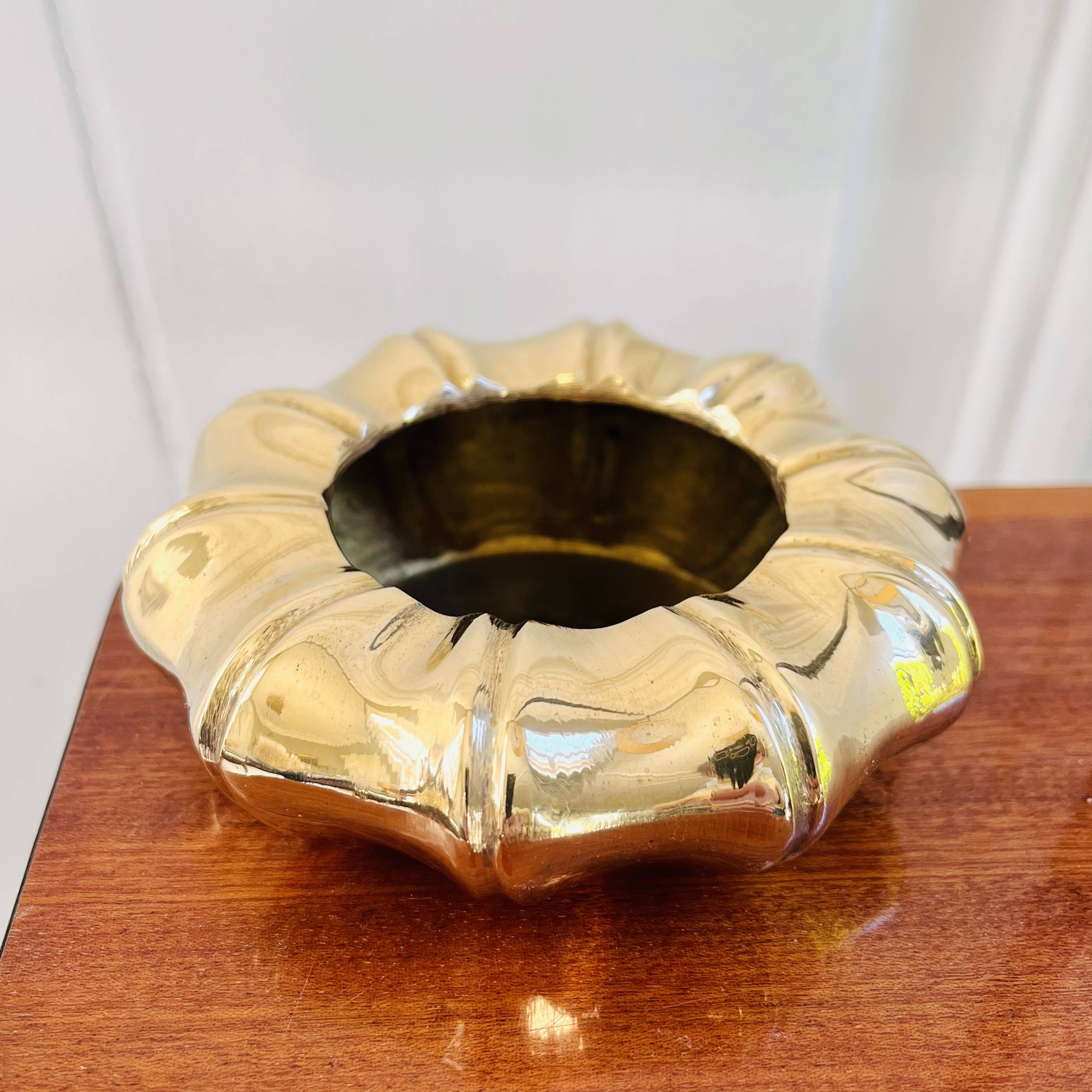 Golden brass ashtray with bamboo decoration.