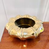 Golden brass ashtray with bamboo decoration.