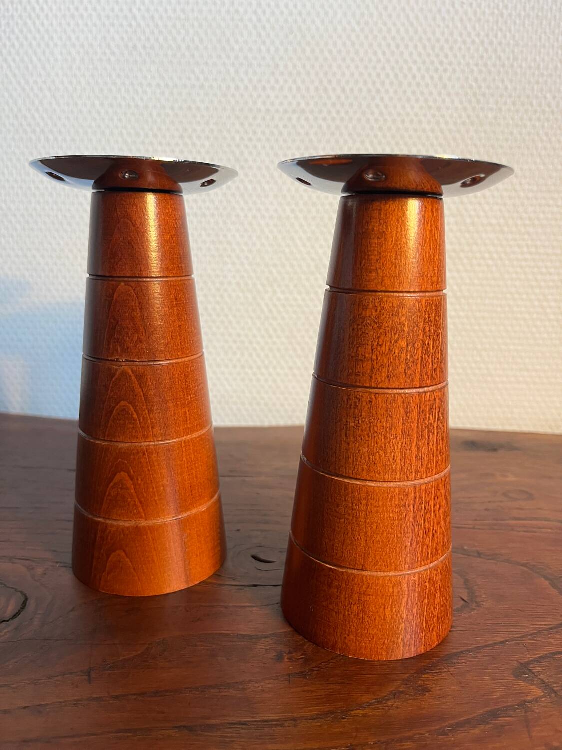 Pair of Guy Degrenne wooden and stainless steel candlesticks