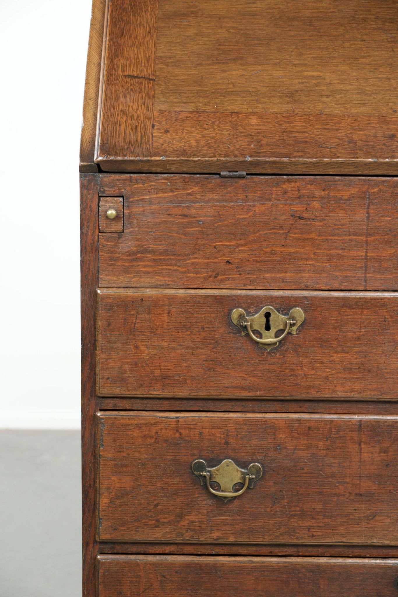 Antique English oak secretary from the 18th century with a stepped interior