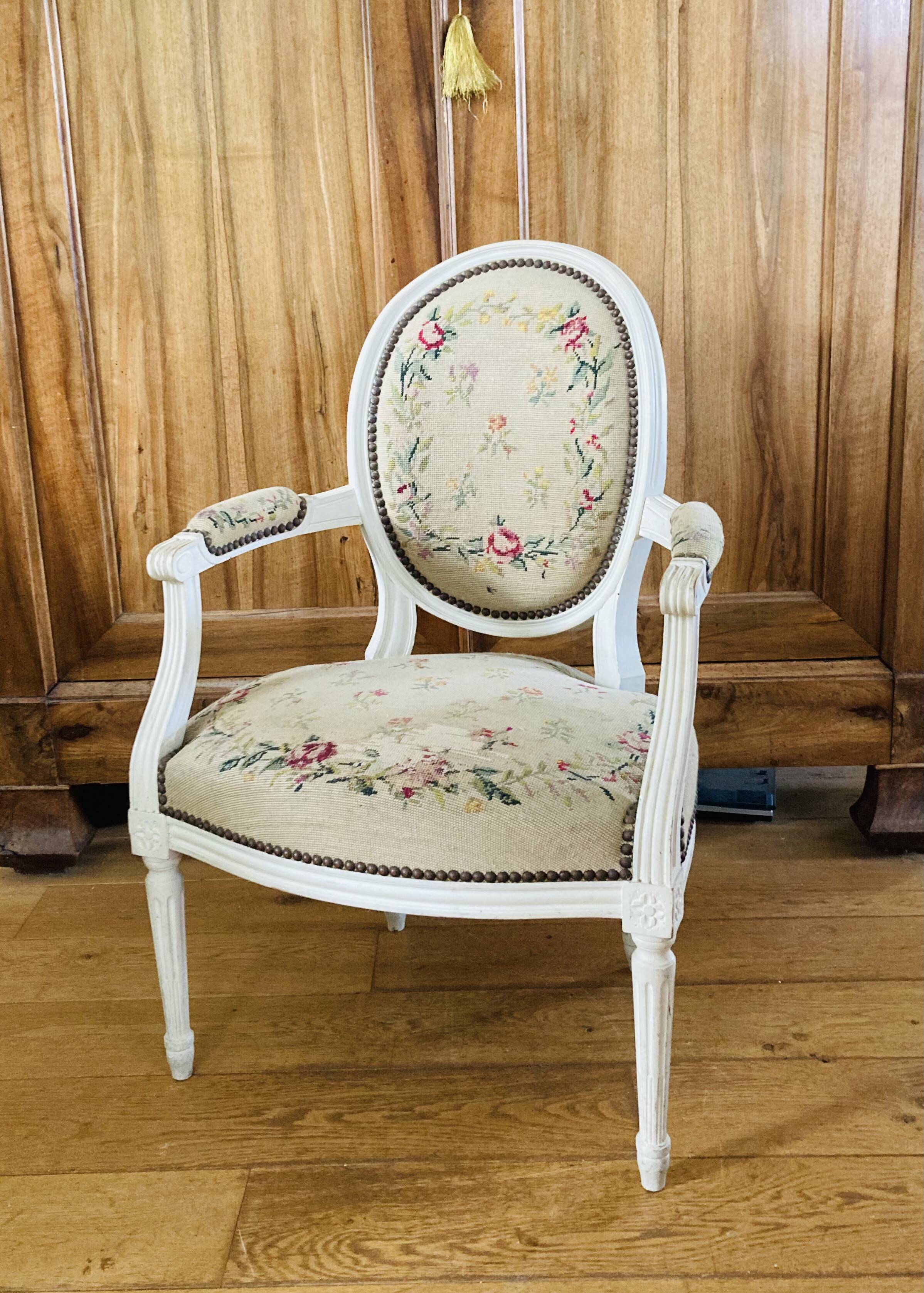 Upholstered armchair with cross-stitch in the Louis XVI style, 19th century.