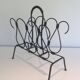 Magazine rack in leather and black lacquered metal. Attributed to Jacques Adnet