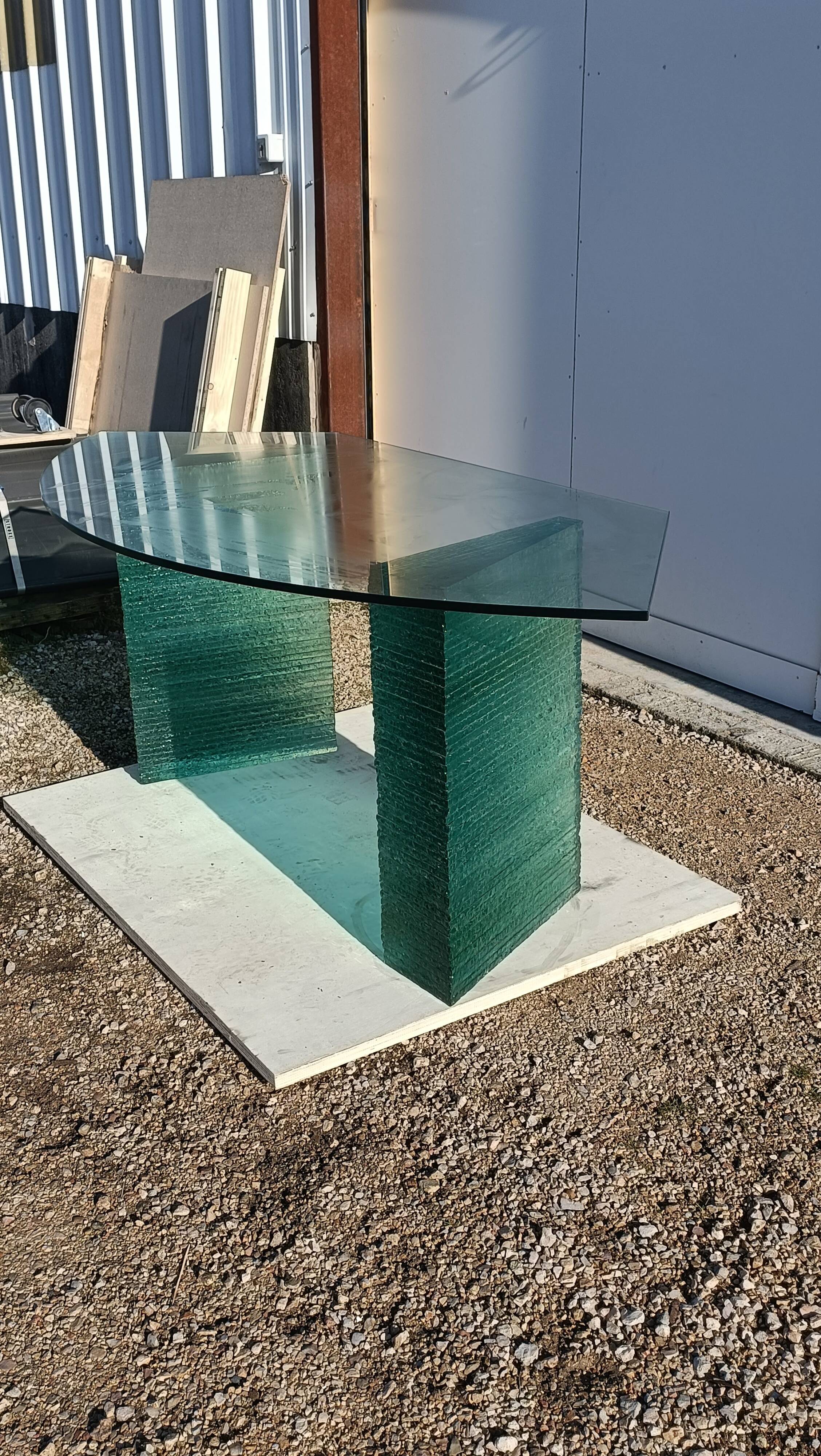 Solid glass desk with a half-moon top.