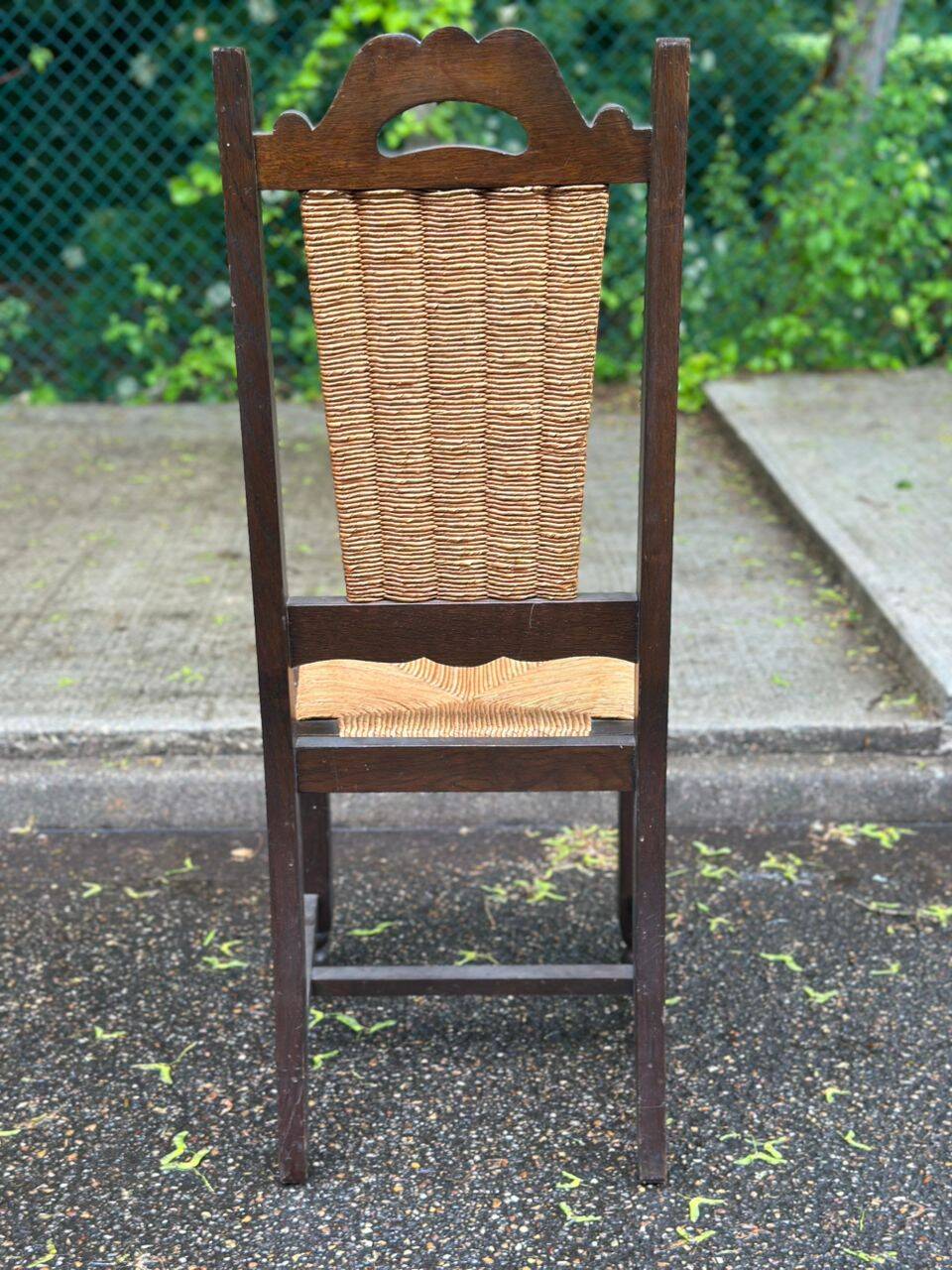 4 Basque solid wood dining chairs with carved straw seats.
