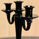 Set of four black glass candle holders.