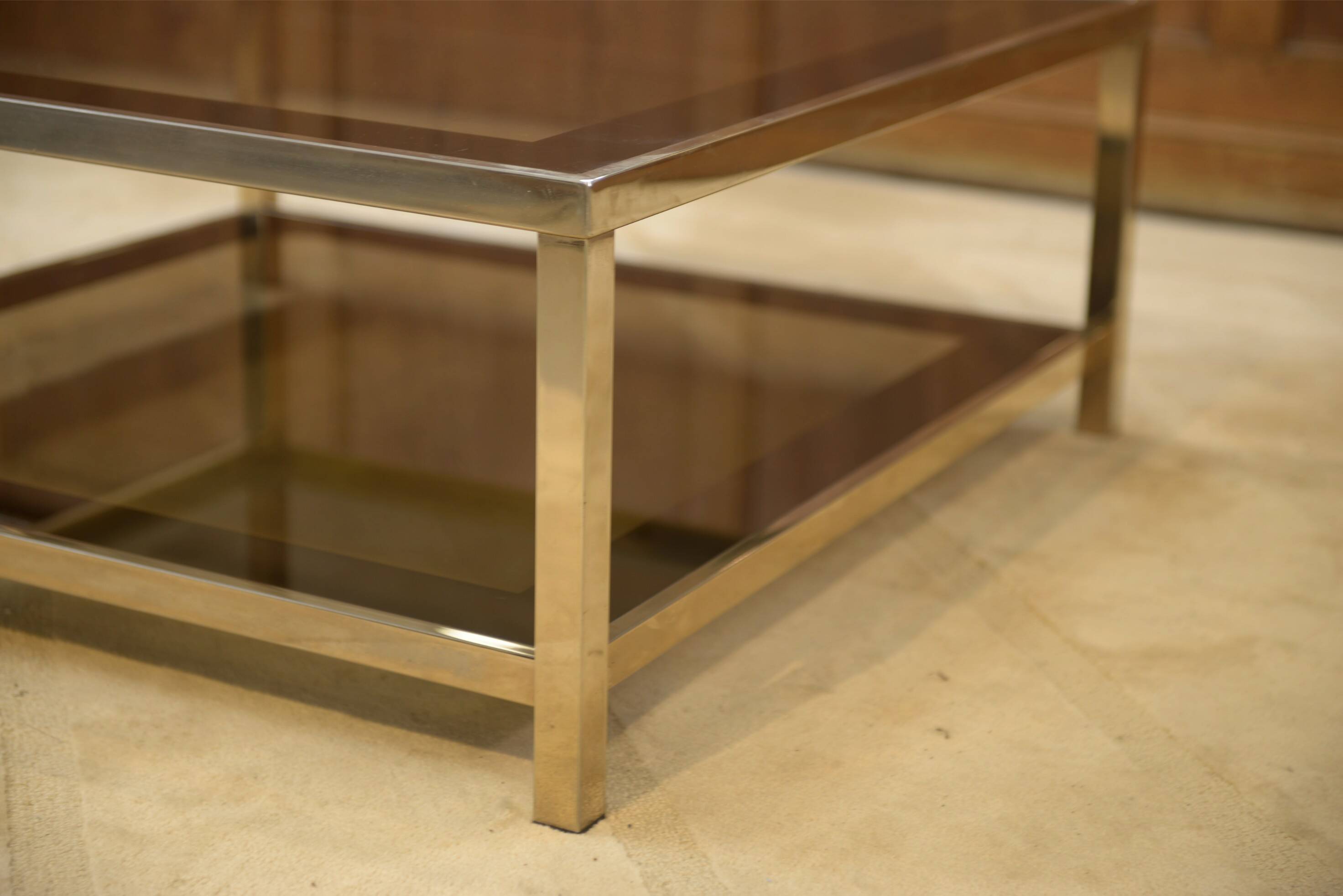Hollywood Regency coffee table in smoked glass with mirrored framing from the 1970s.