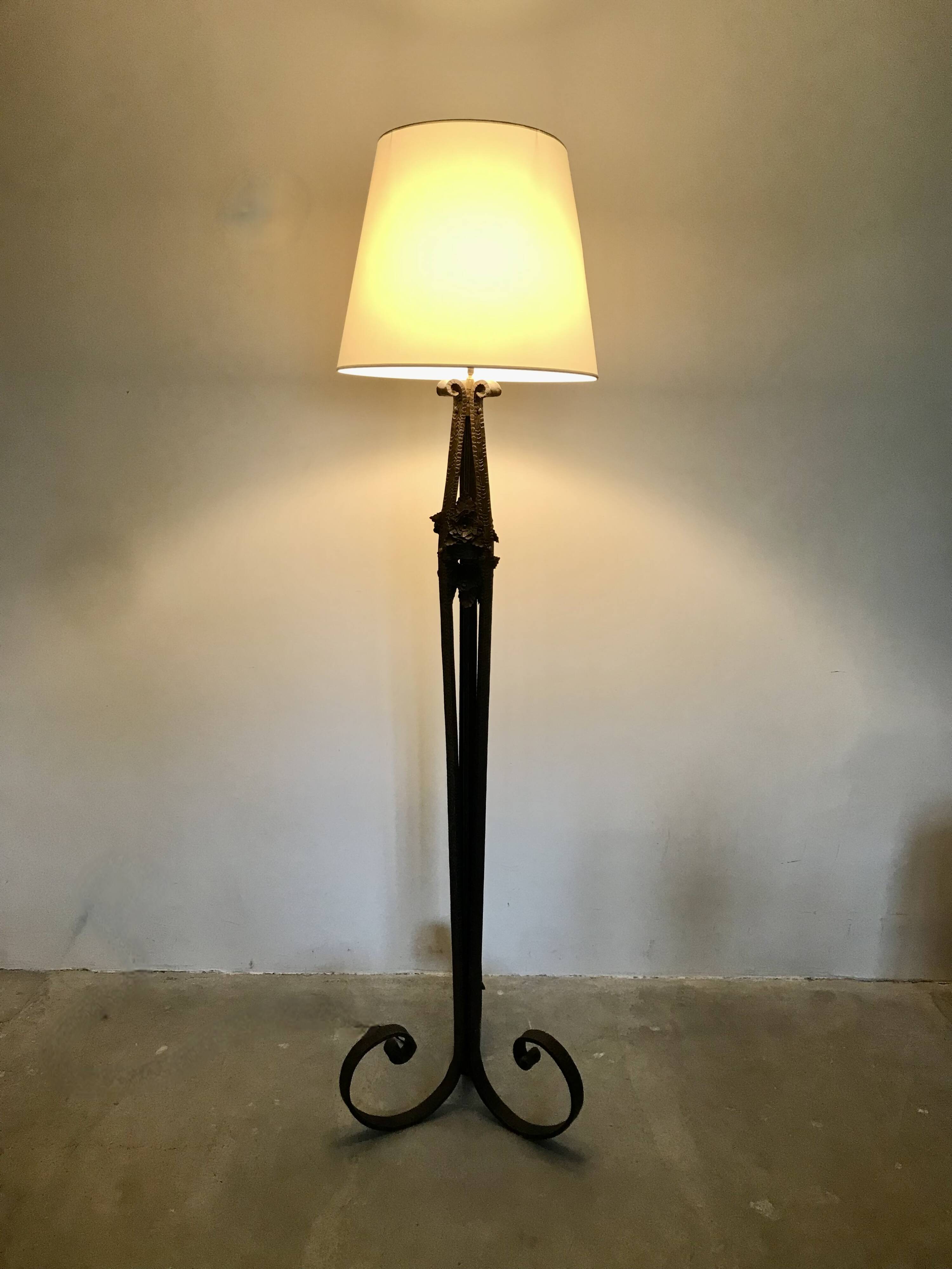 Art deco wrought iron floor lamp decorated with flowers, circa 1930.