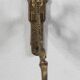 Vintage brass coat hook with marine creature motif and medallion.