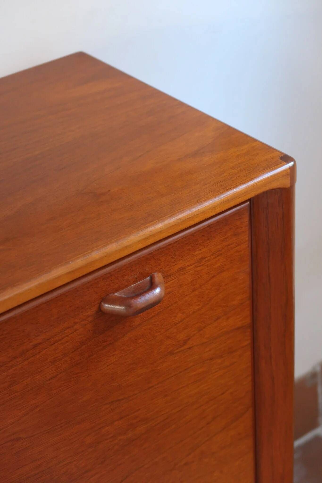 Vintage teak bar cabinet with black glass interior.