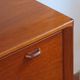 Vintage teak bar cabinet with black glass interior.