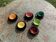 Coffee service composed of 5 cups and saucers in black earthenware and different colored interiors