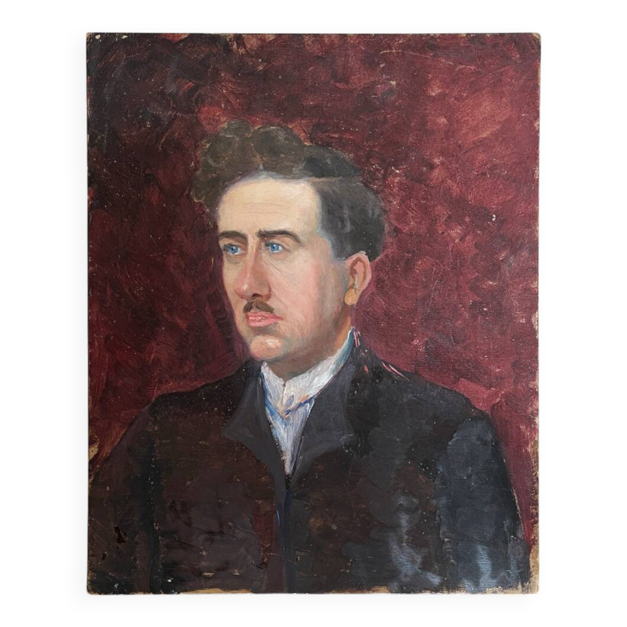 Old oil painting on cardboard portrait of a man in a dark suit