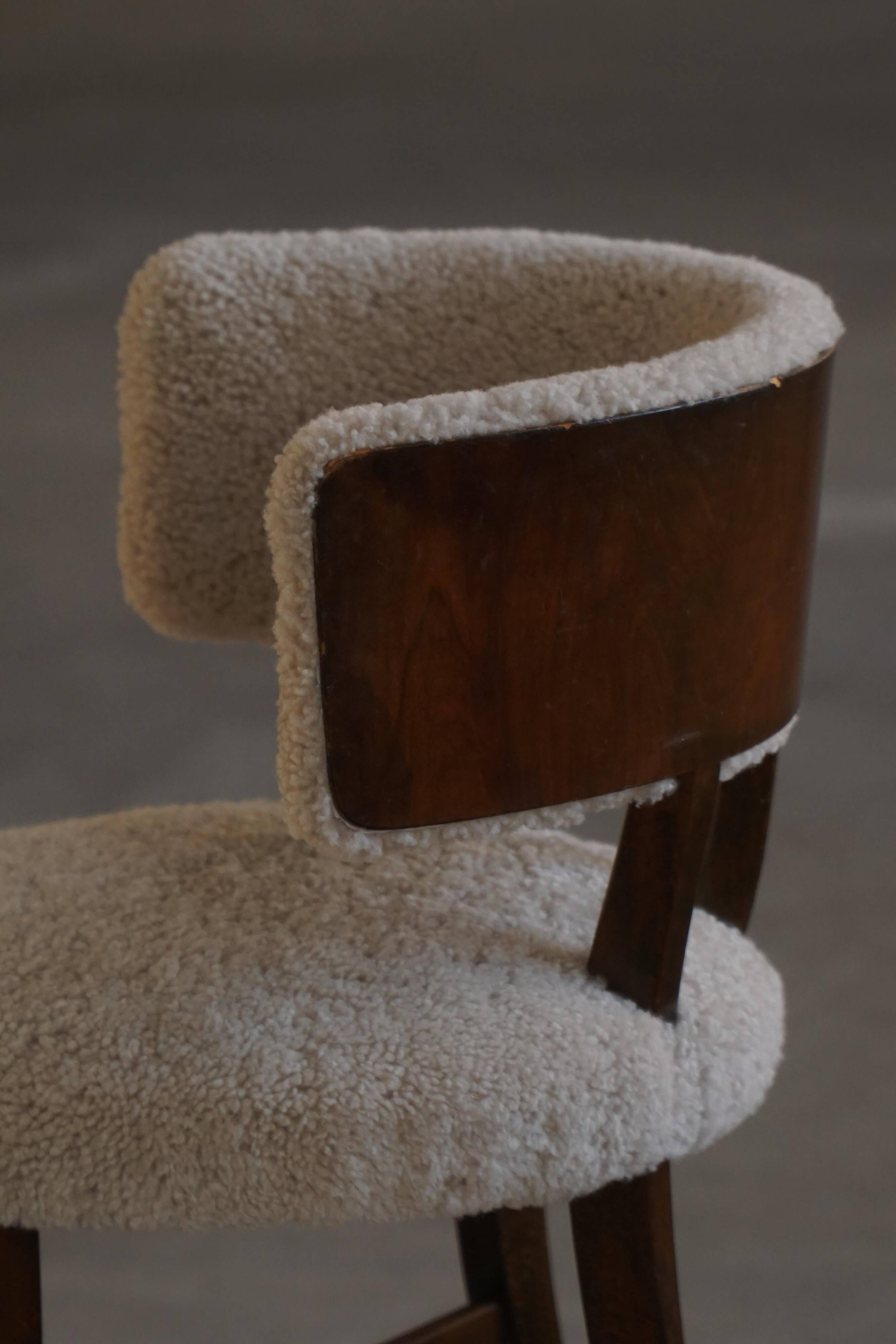 A modern Danish elegant low-back chair, reupholstered in lambswool, 1940s.