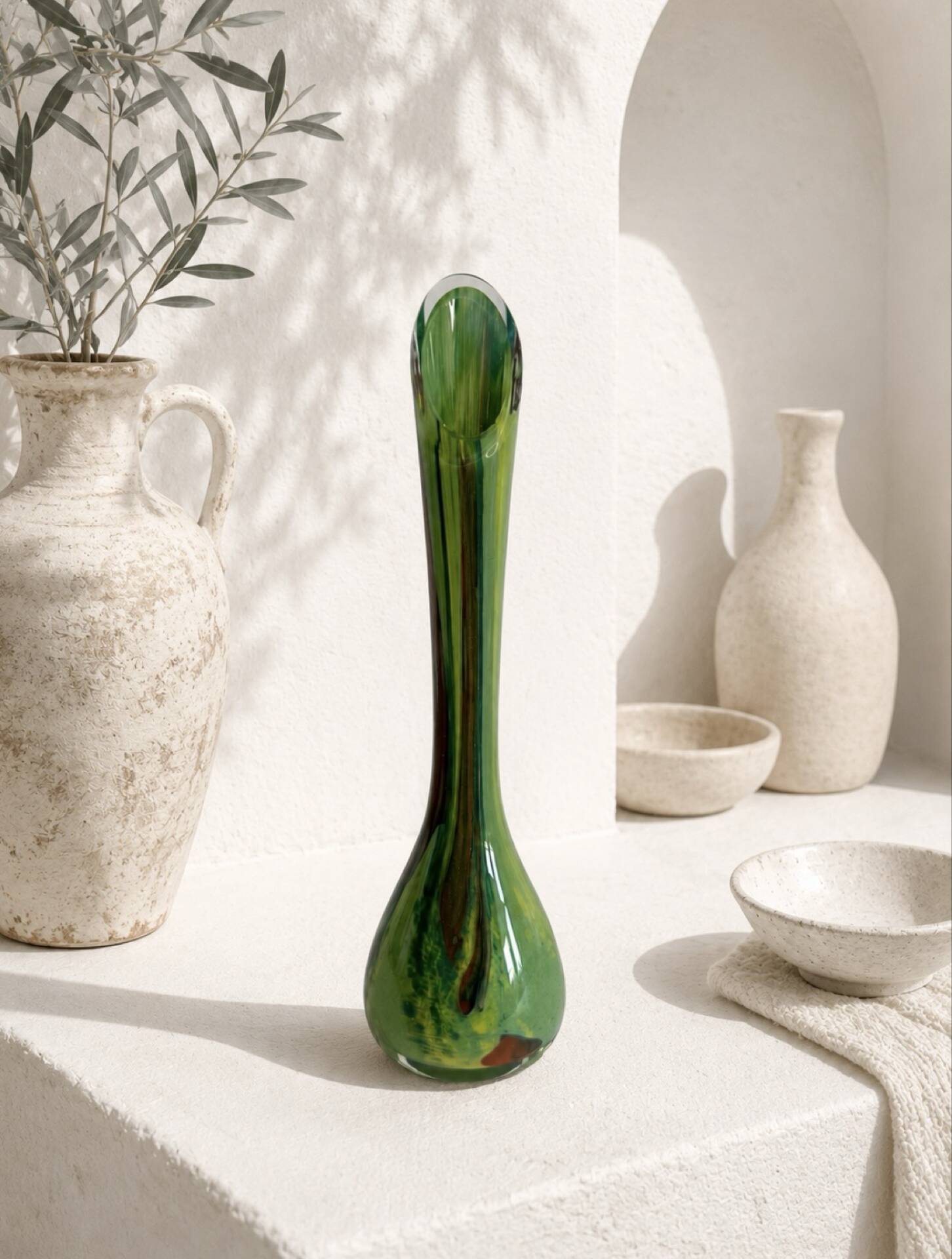 Single flower vase in blown green glass