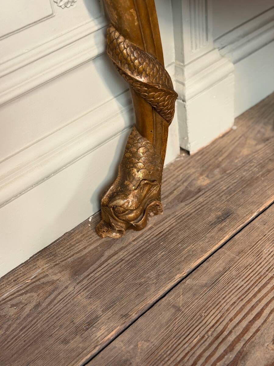 Golden wooden console, four legs adorned with sea monsters, purple breccia marble, around 1900.