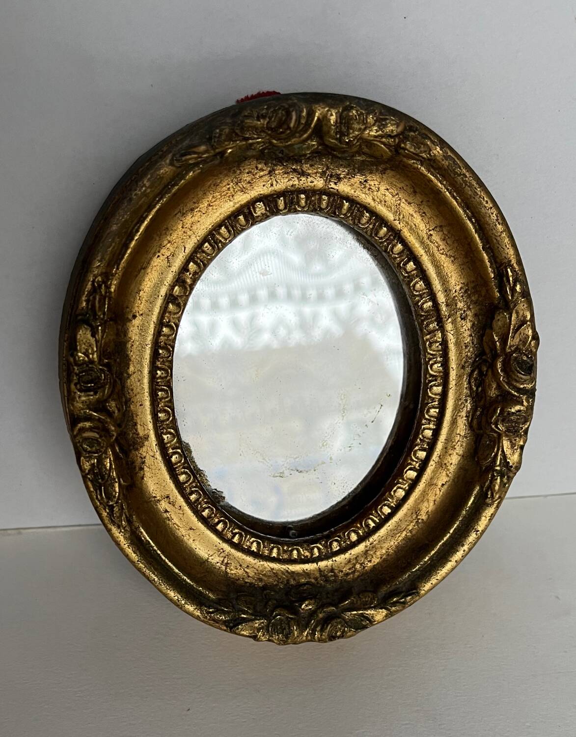 Small old mirror in gilded wood