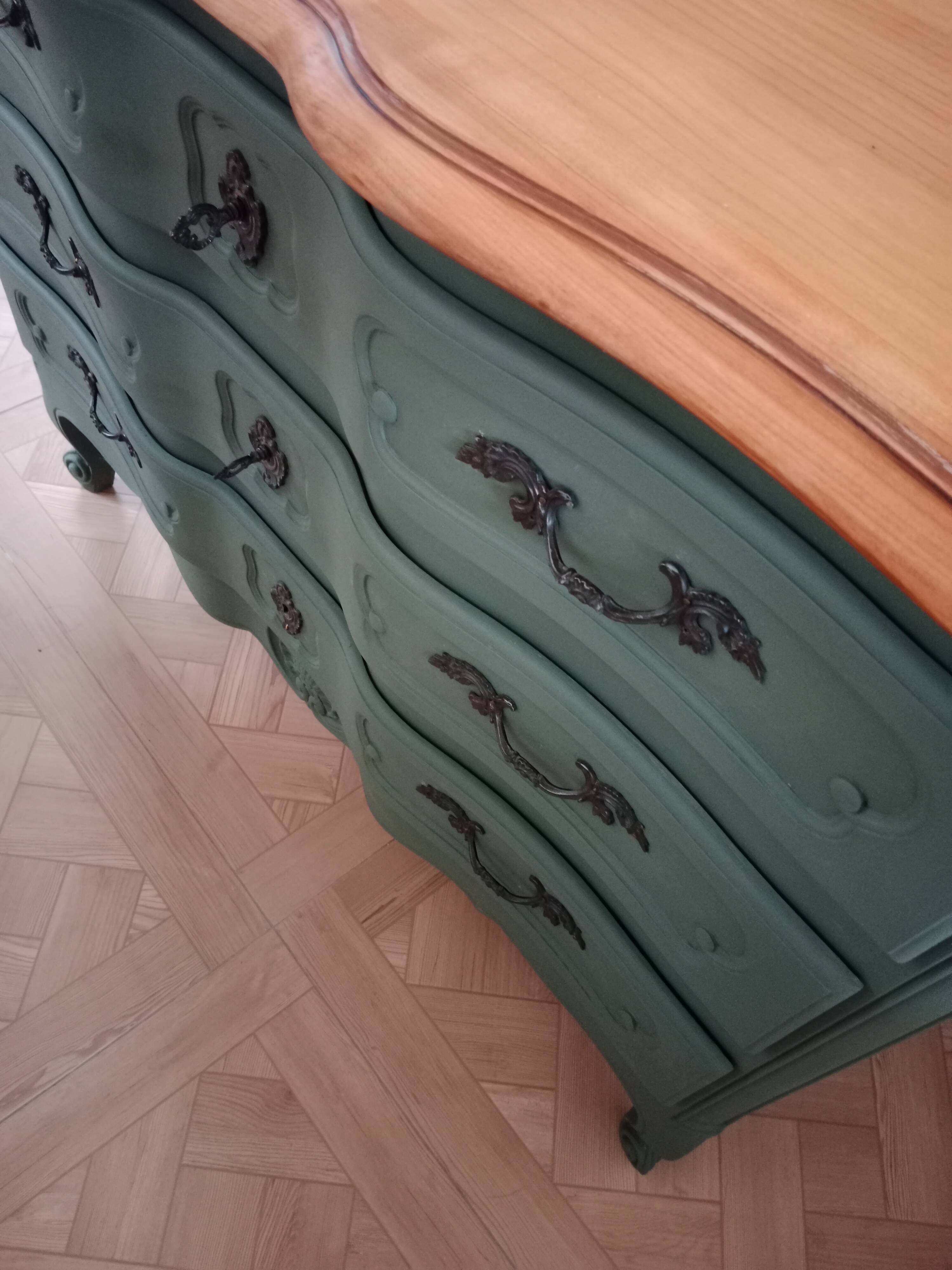 Dark green patina crossbow chest of drawers