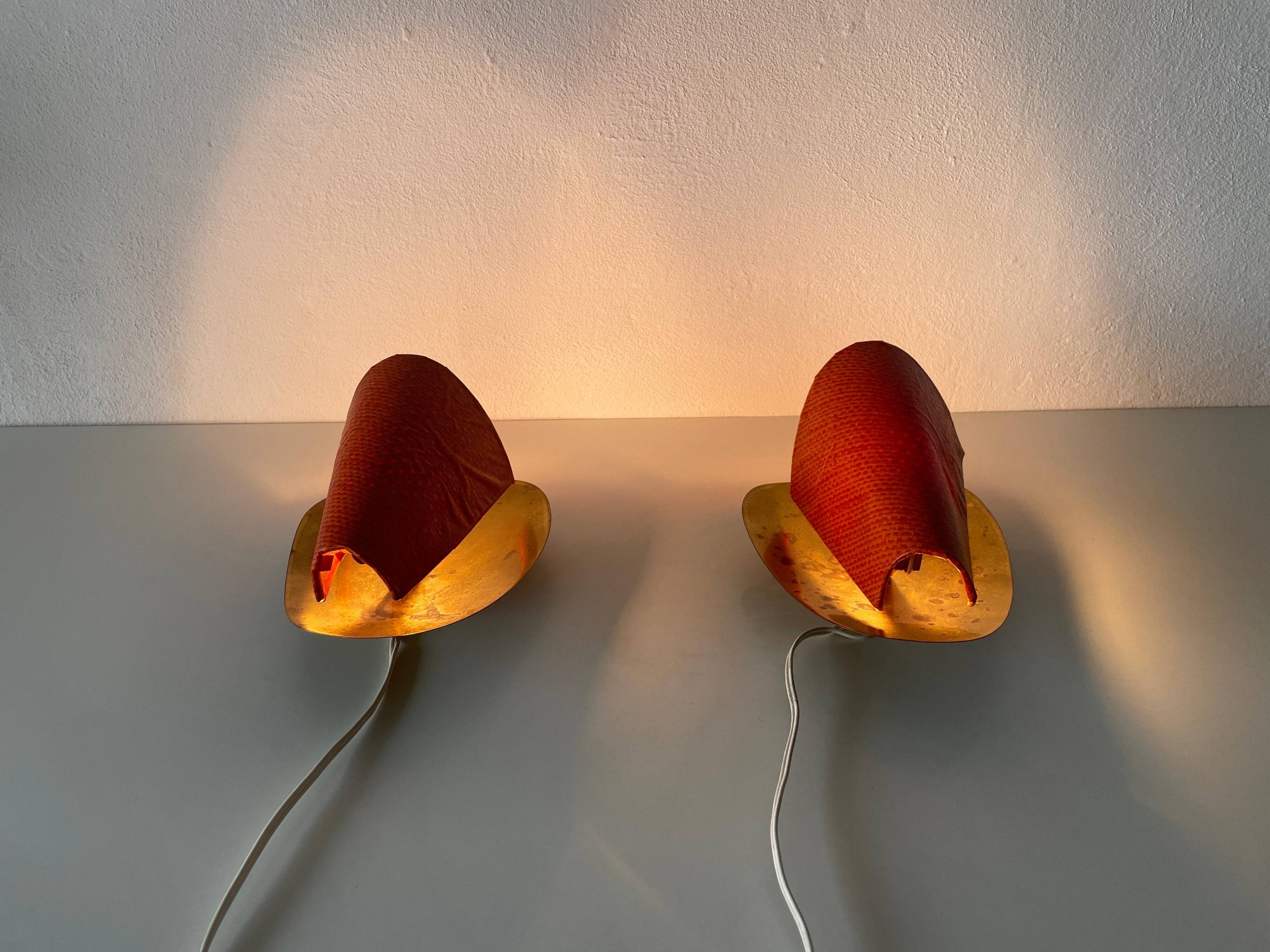 Pair of orange plexiglass and curved brass wall lights, 1950s, Germany