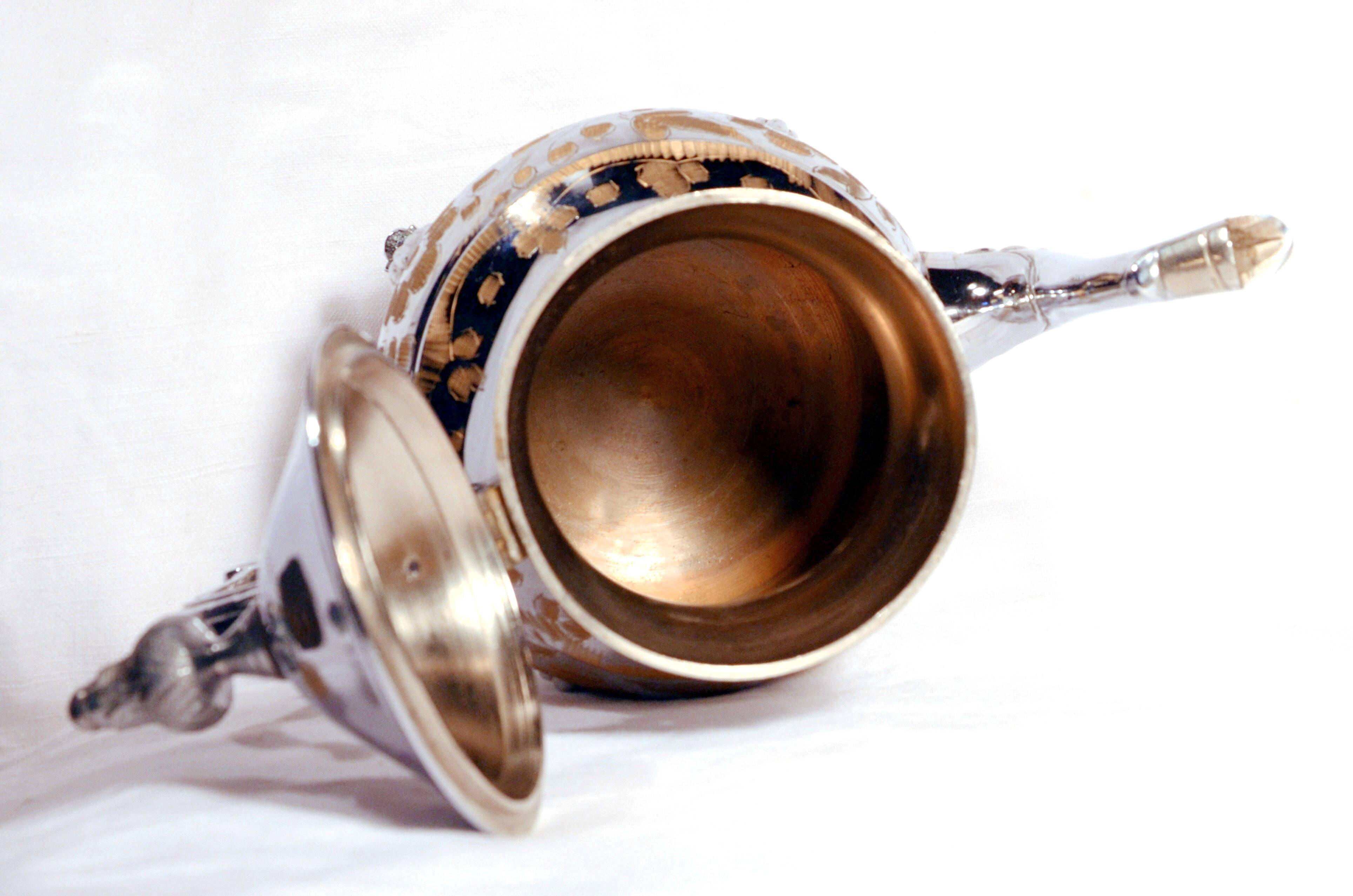 Oriental teapot in chrome metal and brass, 12x19cm