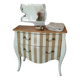 Curved commode with beige and white stripes.