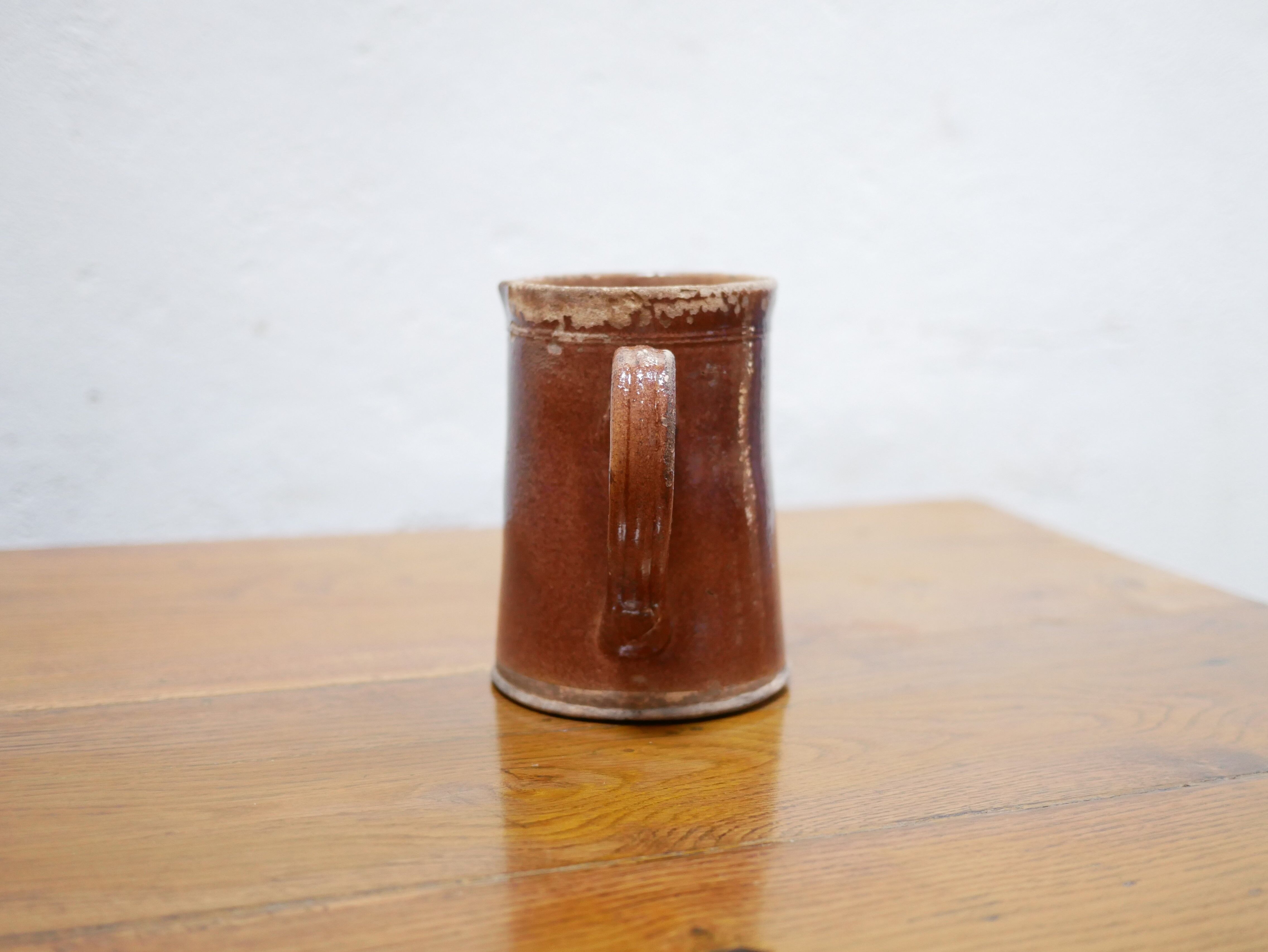 Vintage pitcher in glazed terracotta