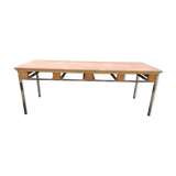 Vintage modernist table with metal tubular base and top covered with oilcloth.