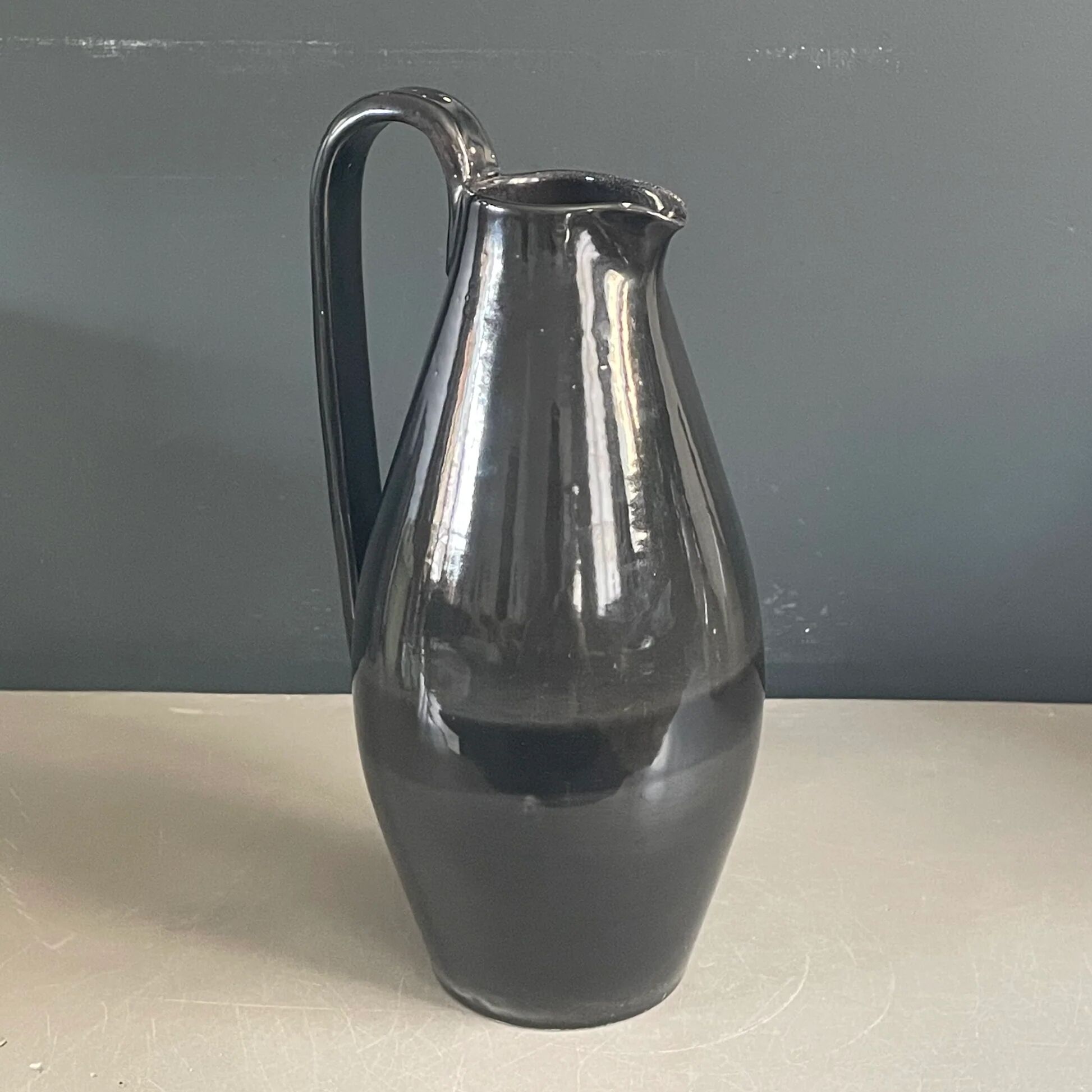 Black glazed ceramic pitcher signed M Azouit