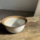 Small thick stoneware bowl with a stylised flower pattern in white on the outside, b