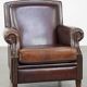 Dark brown sheepskin armchair finished with decorative nails