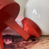 Red plastic wall light with a white opaline glass globe.