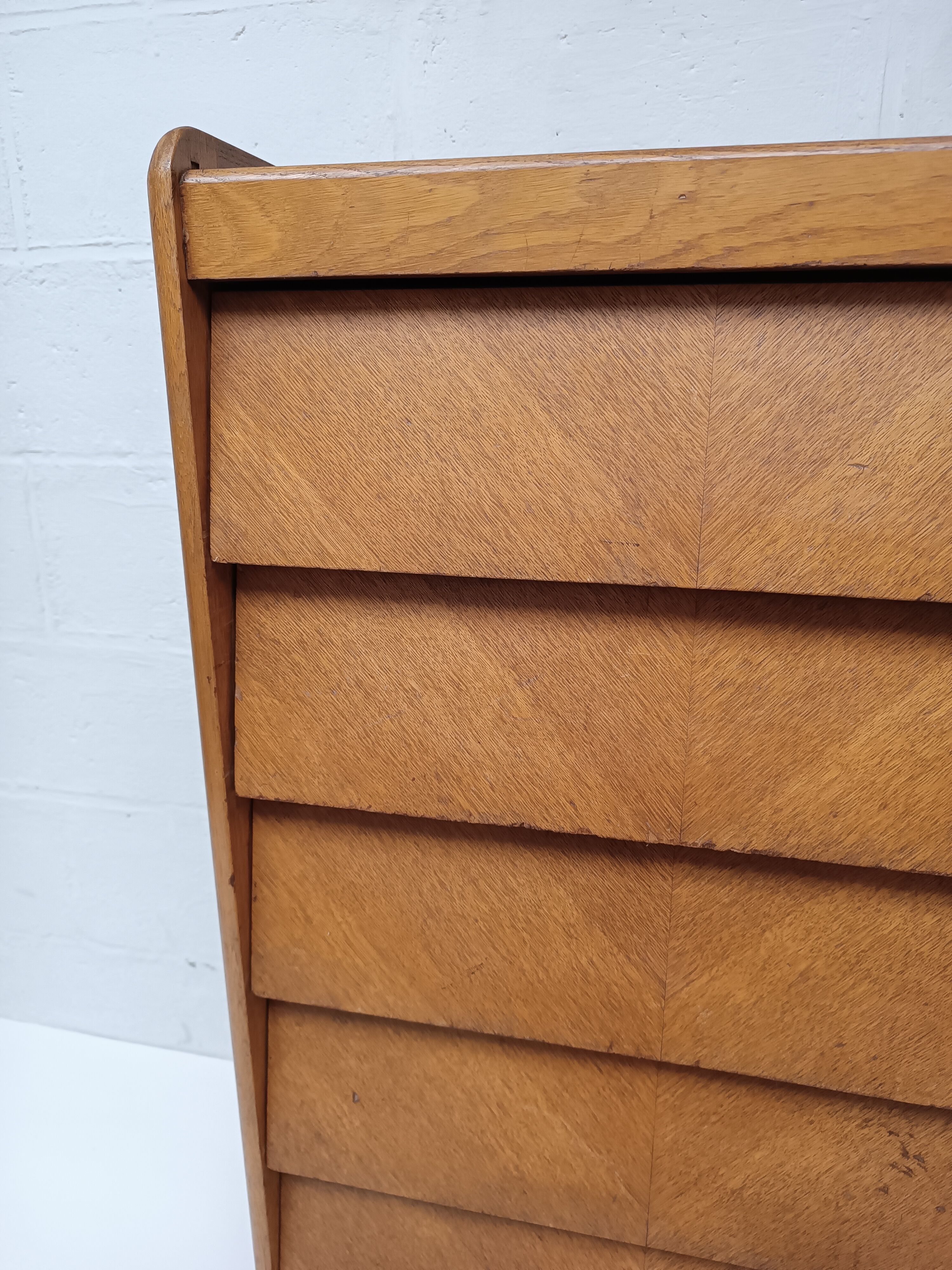 High wooden chest of drawers in the 50s