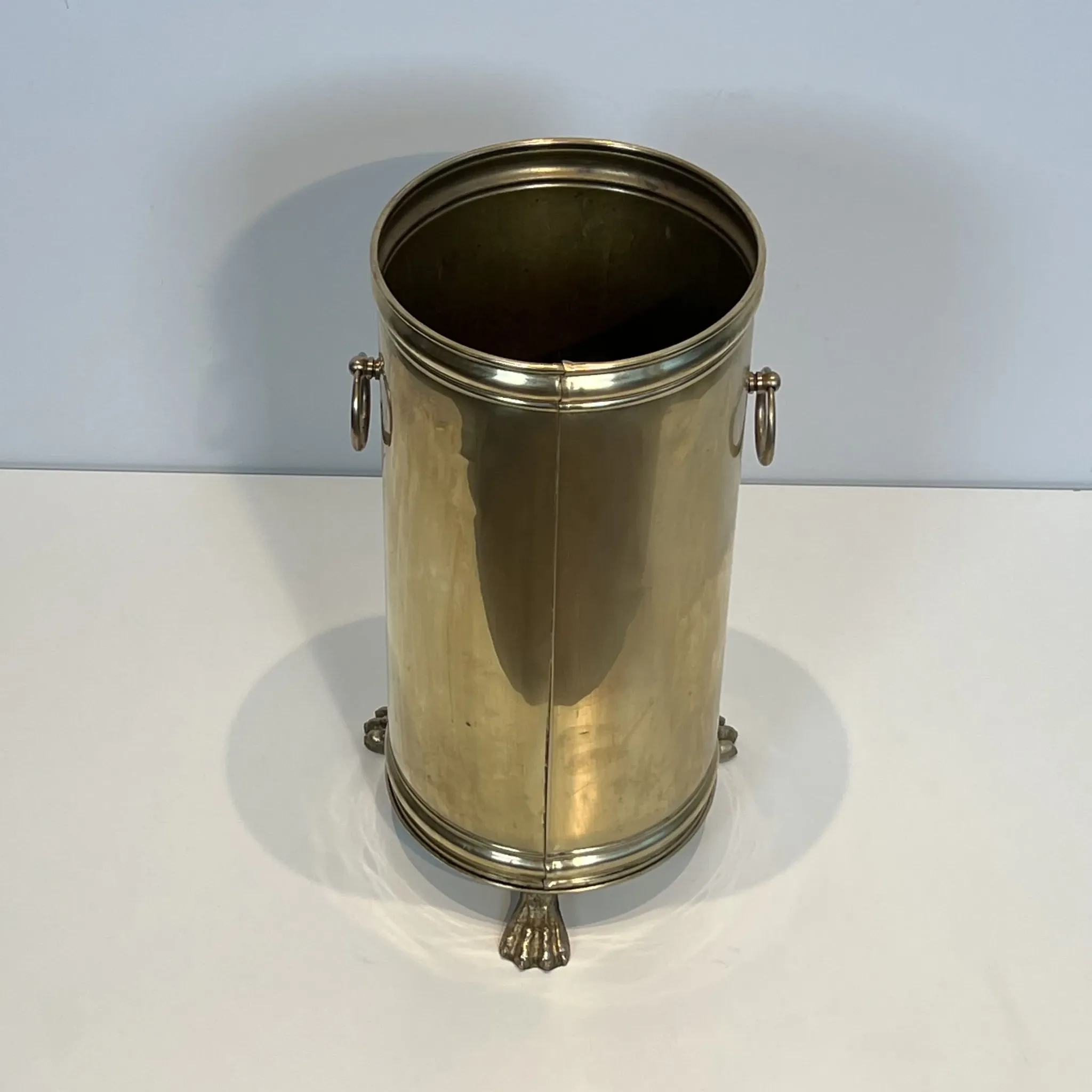Cylindrical Brass Umbrella Stand with Ring Handles and Claw Feet.