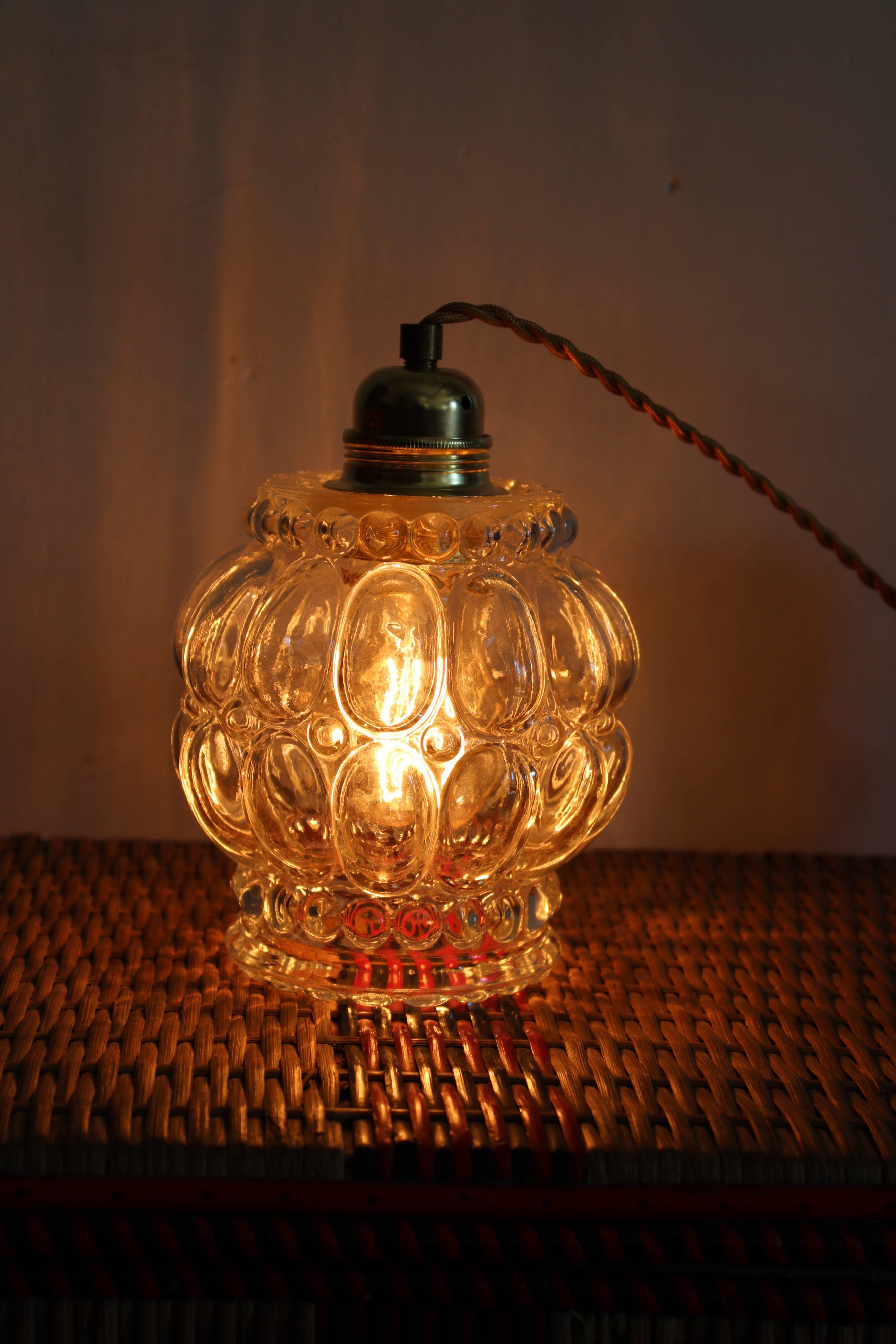 Moulded glass globe hand lamp