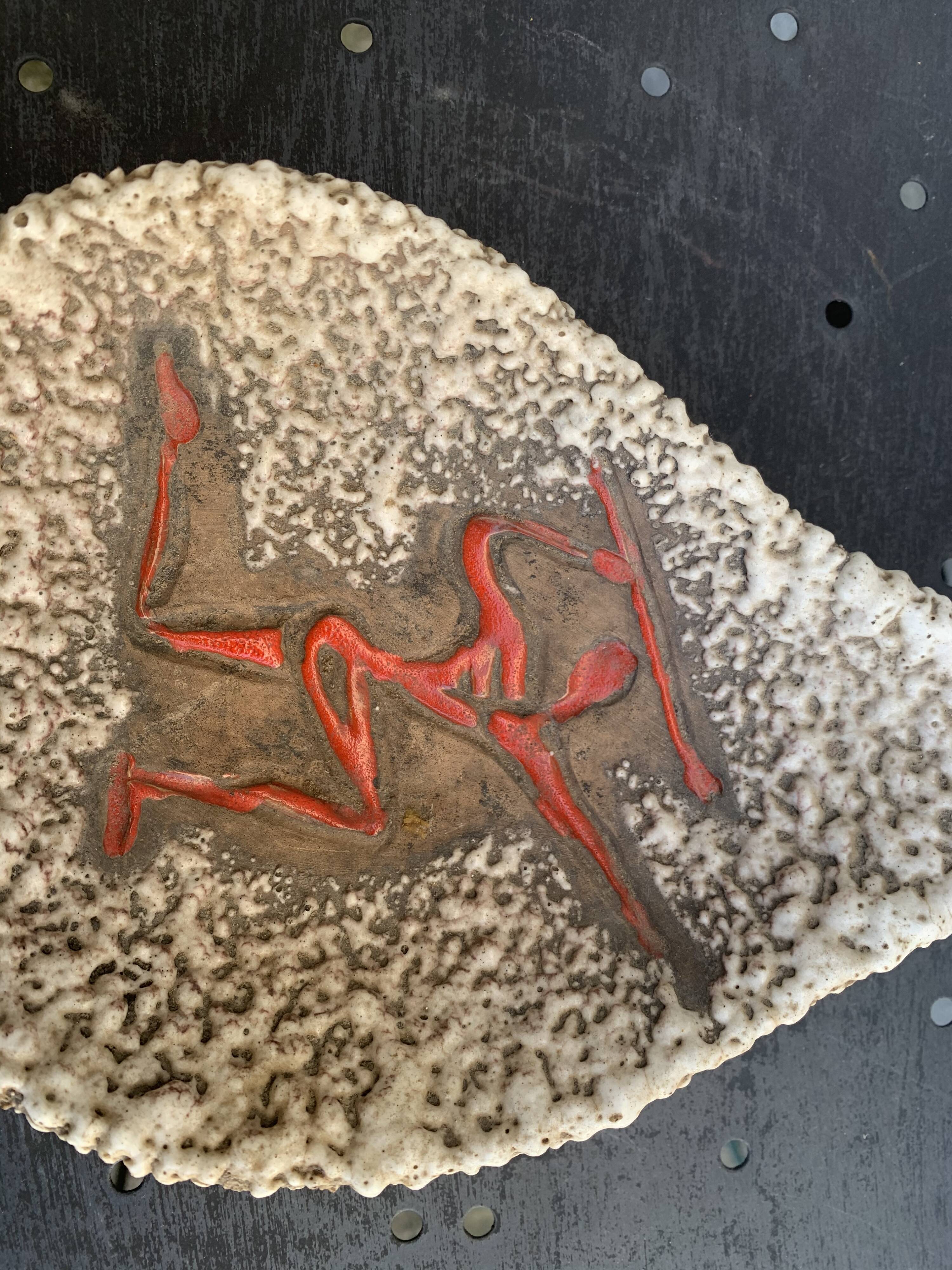 Glassed ceramic cut enamelled prehistoric warrior motif vintage red 1950