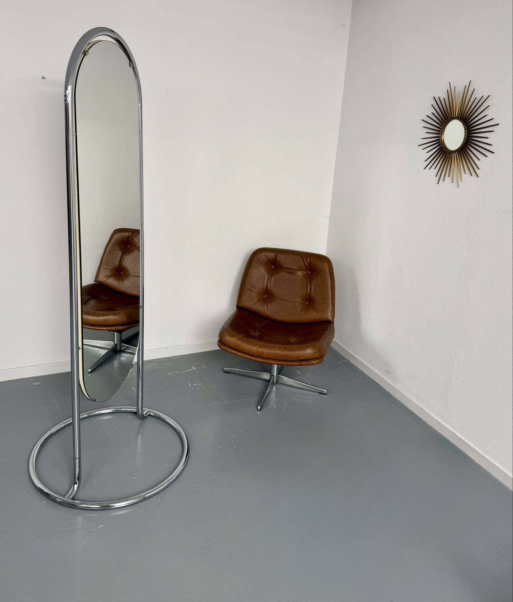 Large freestanding chrome metal full-length mirror in 1970s design.