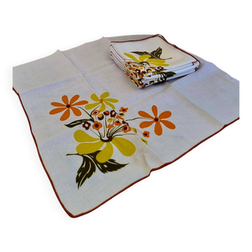 Set of 8 vintage 1970s table napkins with orange and yellow flowers.