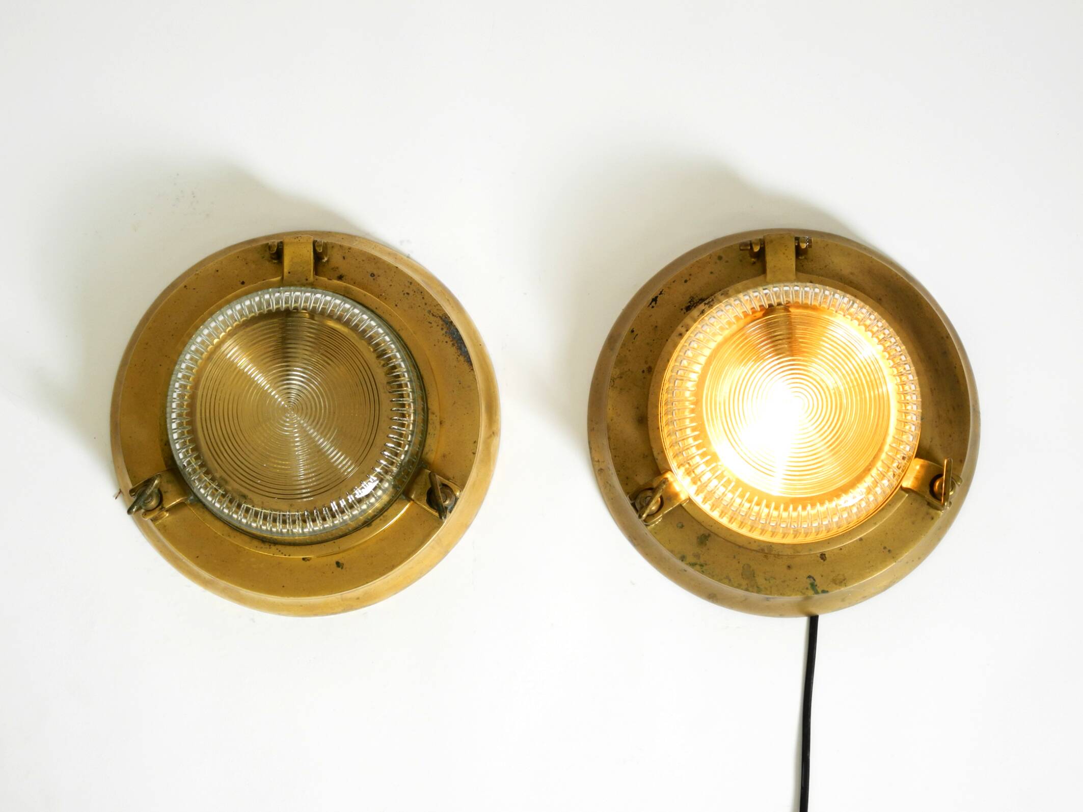 A pair of large, heavy 50s maritime ship wall lamps made of brass and glass
