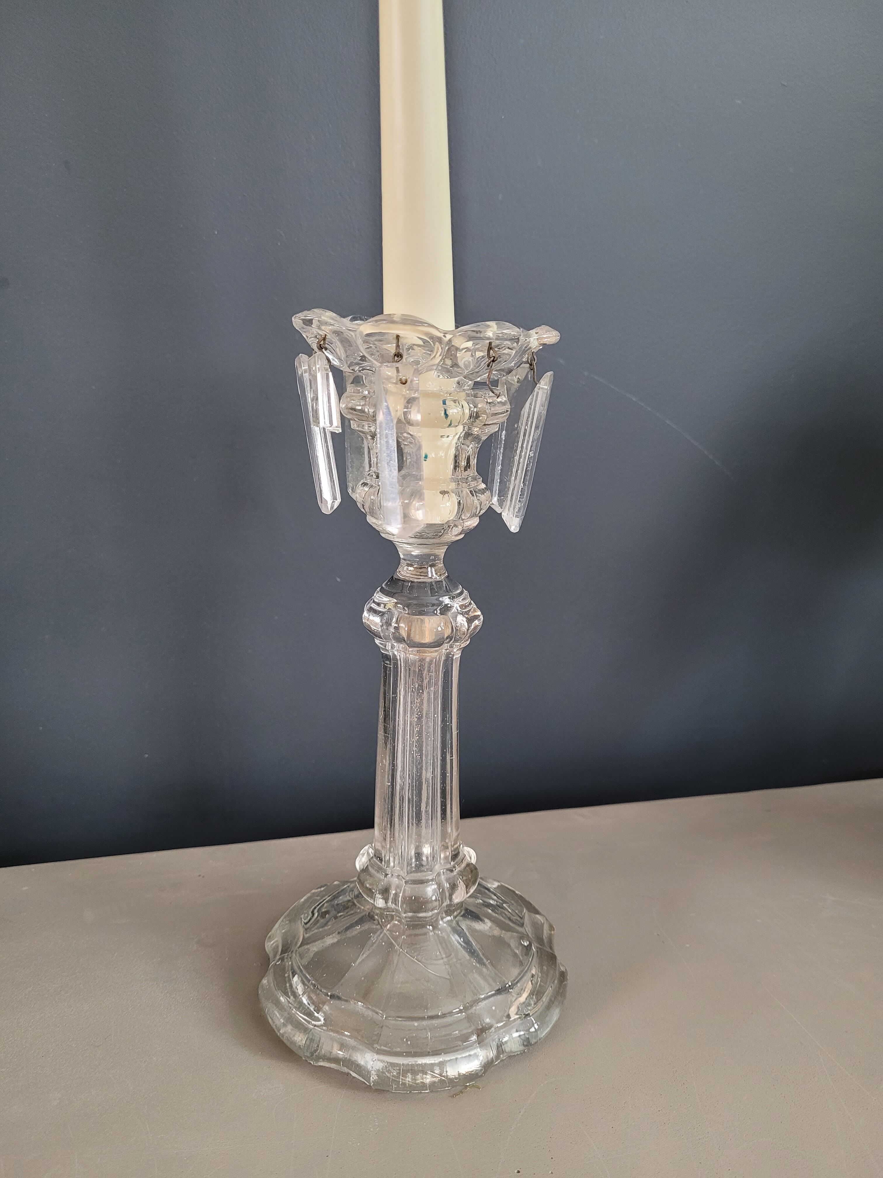 Old candlestick with molded glass stamps