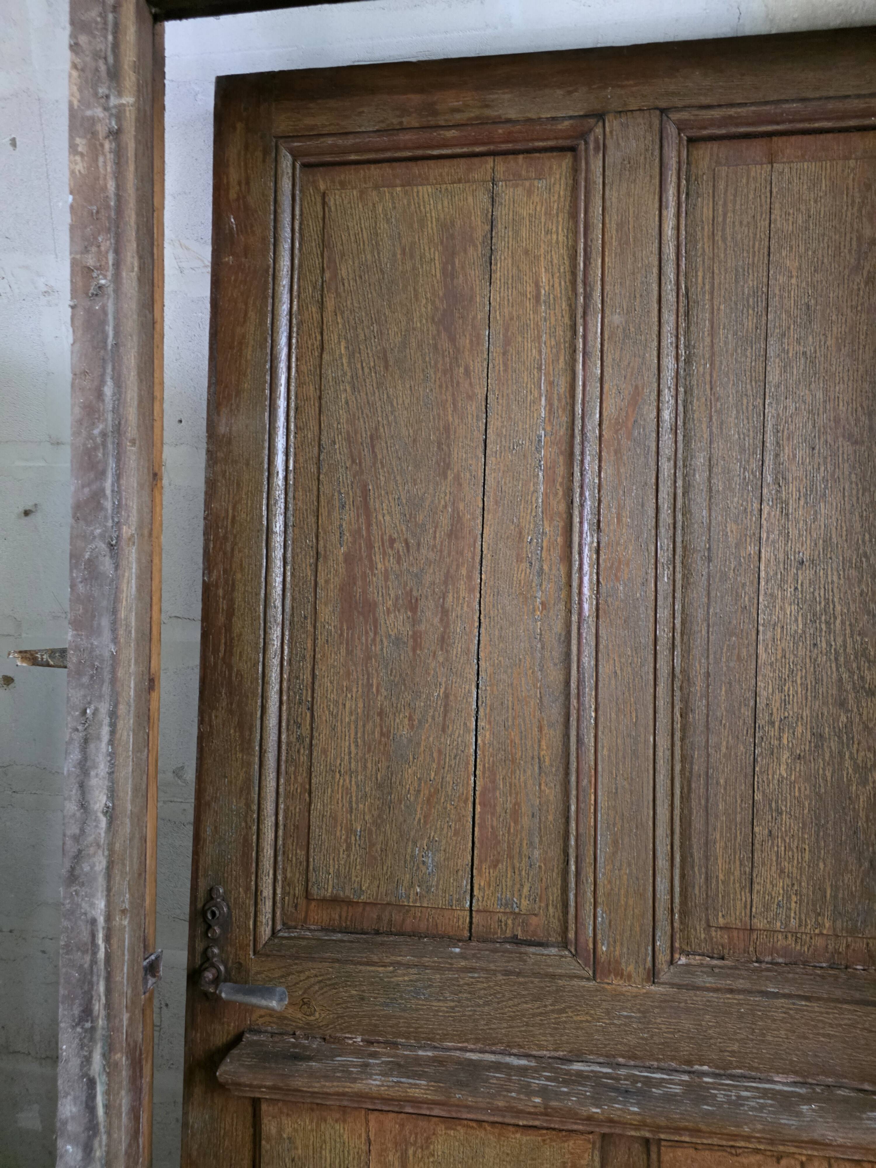 Old solid oak front door with frame and transom from the 19th century.