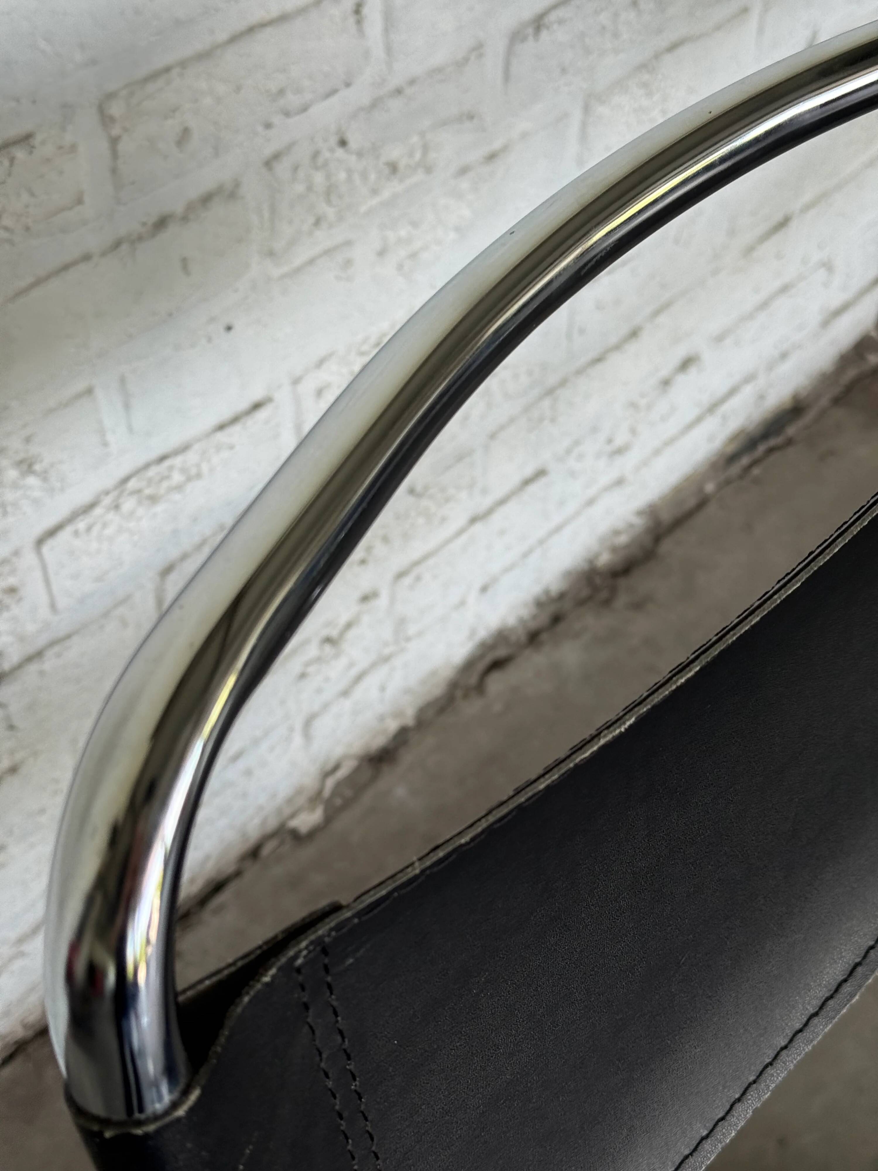 Vintage cantilever chairs in black saddle leather and chrome.