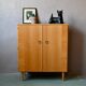 Vintage 1960s shoe cabinet in light wood and chrome metal.