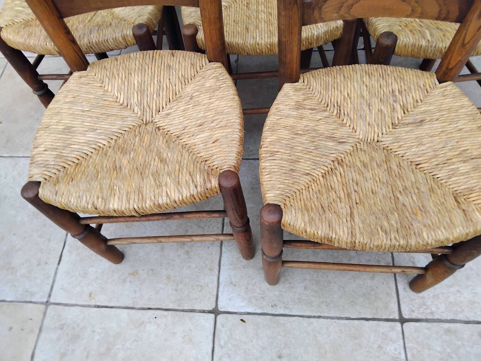 8 vintage straw chairs in the style of Charlotte Perriand.