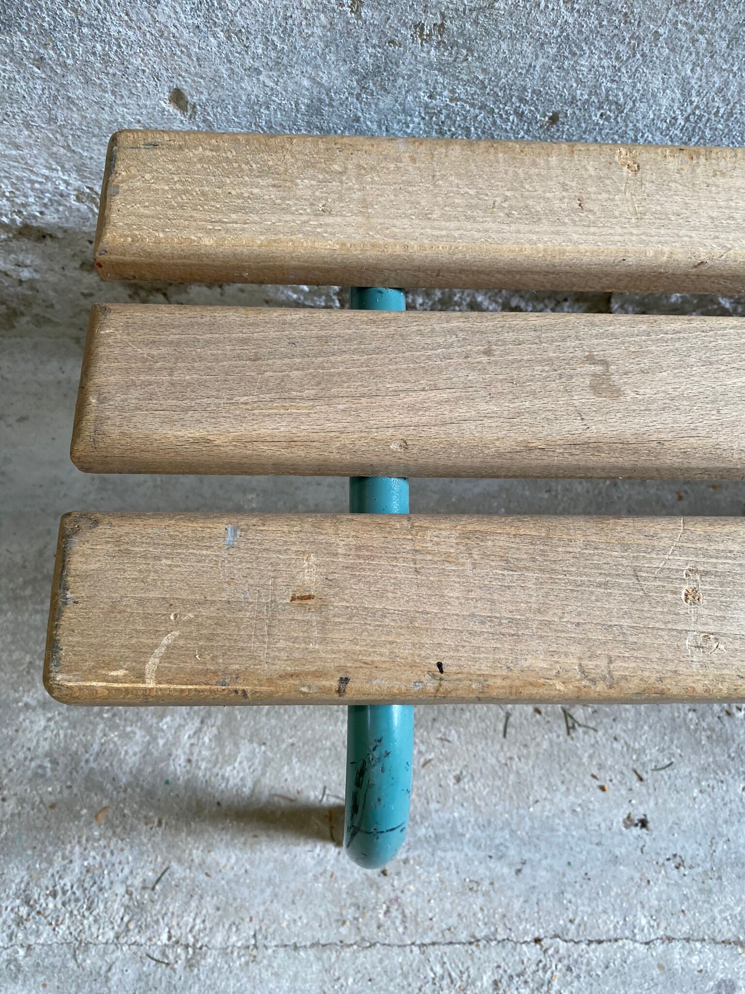 Vintage wood kindergarten bench and tubular structure in long