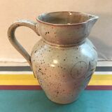Old gray pitcher with black drawings and vintage stamped handle