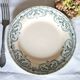 Mismatched antique flat plates made of ironstone pottery.