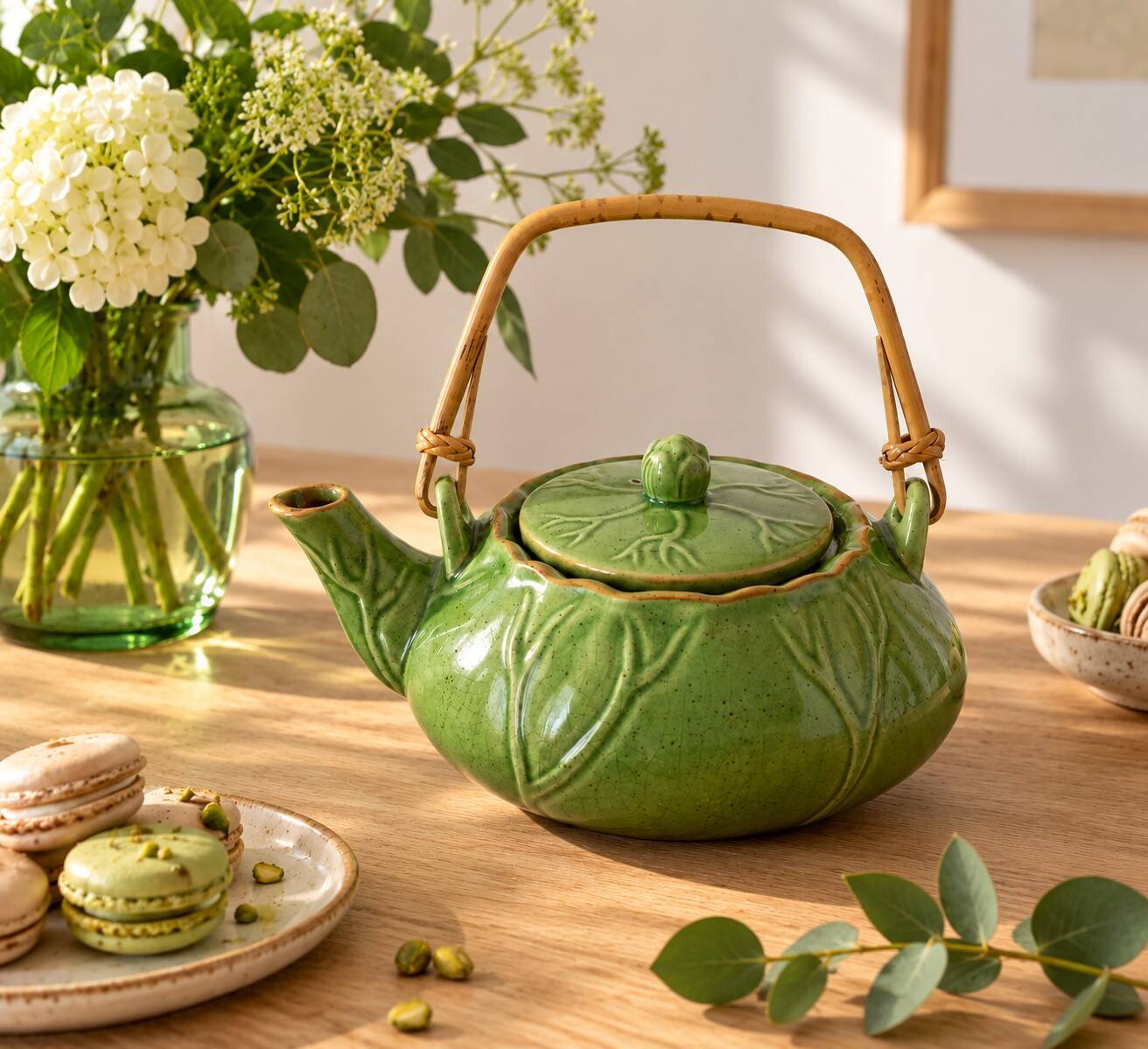 Vintage green teapot with lotus decoration and bamboo handle.