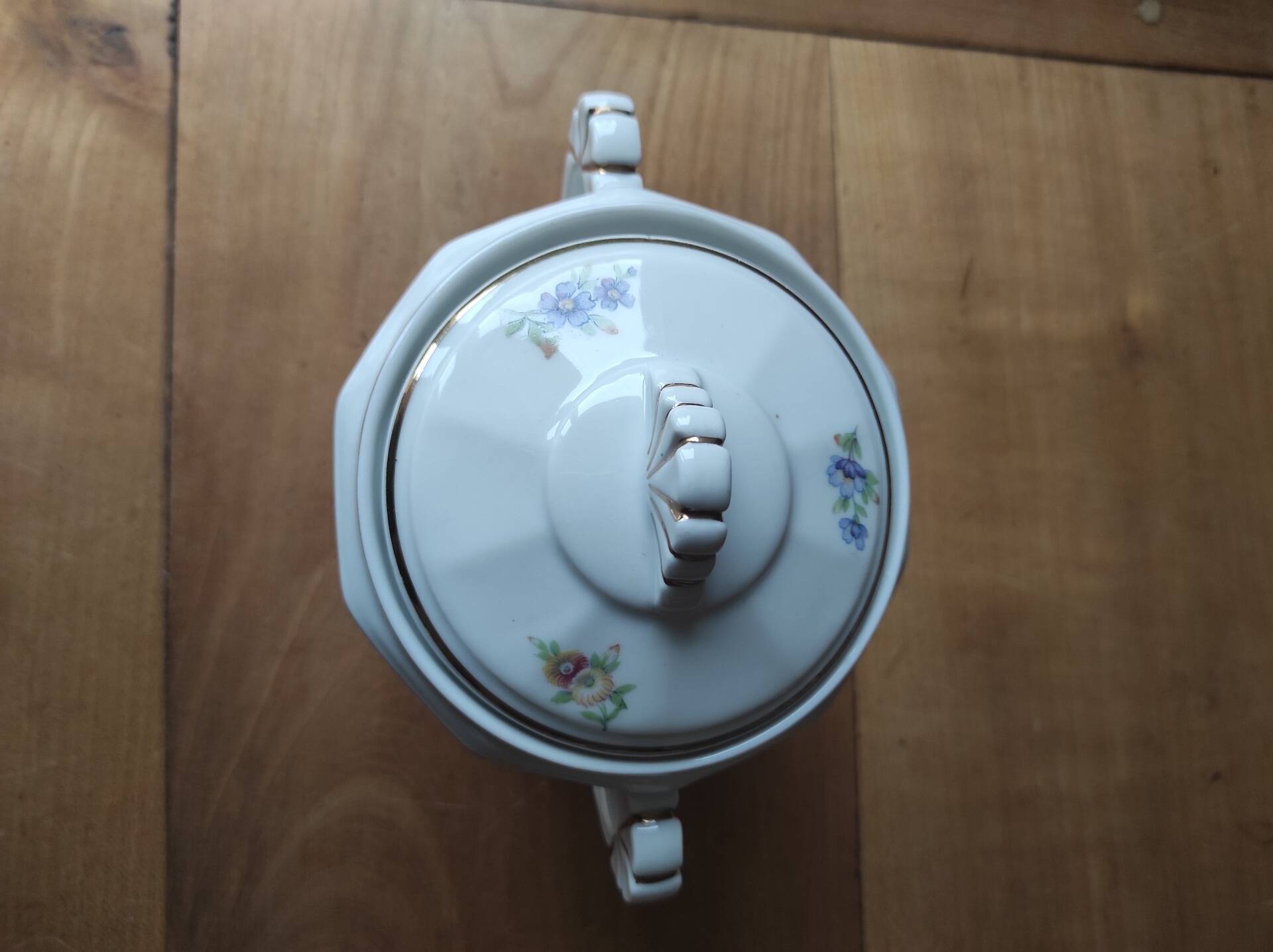 Antique porcelain sugar bowl with a decagonal base.
